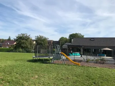 a playground with a slide in a yard at Vakantiewoning De Poort in Zottegem