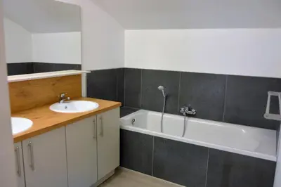 a bathroom with a sink and a bath tub at Vakantiewoning De Poort in Zottegem