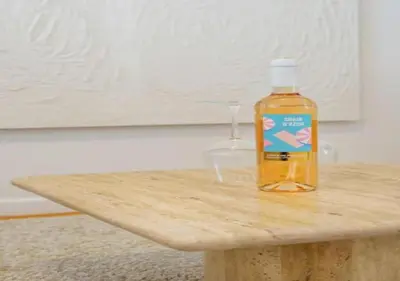 a bottle of alcohol sitting on a wooden table at Top Location - City Center 1BR with Stylish Decor in Antwerp