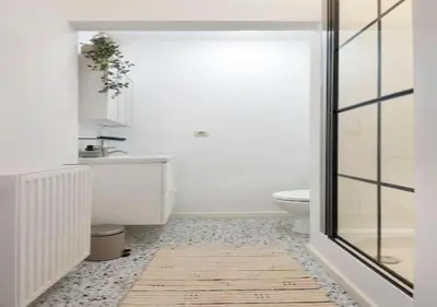 a bathroom with a toilet and a glass door at Top Location - City Center 1BR with Stylish Decor in Antwerp