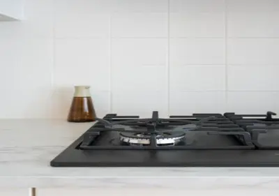 a black stove top in a white kitchen at Hip & Historic Stay Antwerp in Antwerp