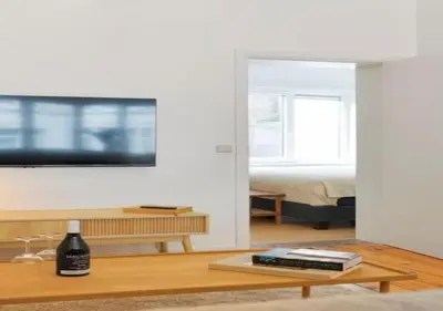 a living room with a tv and a coffee table at Hip & Historic Stay Antwerp in Antwerp