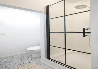 a glass shower door in a bathroom with a toilet at Hip & Historic Stay Antwerp in Antwerp