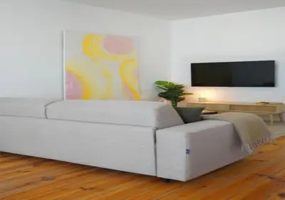 a white couch in a living room with a flat screen tv at Hip & Historic Stay Antwerp in Antwerp