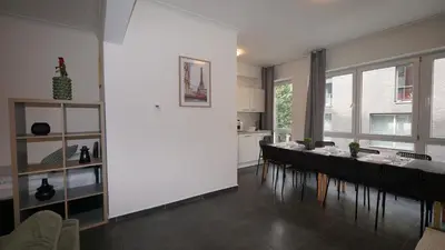 a dining room with a long table and chairs at Consci apartments in Antwerp