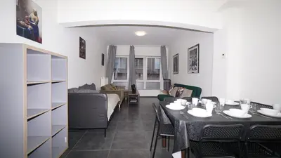 a living room with a table and a couch at Consci apartments in Antwerp