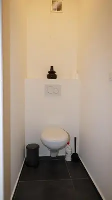 a bathroom with a white toilet in a room at Consci apartments in Antwerp