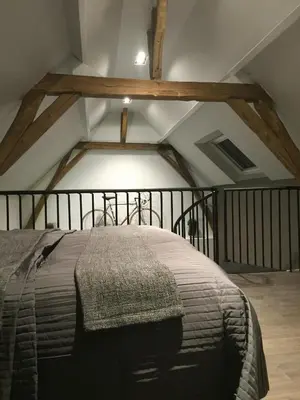 a bedroom with a large bed in a attic at B&B Den Engel in Kortenberg