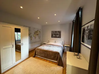 a bedroom with a bed and a desk and a window at B&B Den Engel in Kortenberg