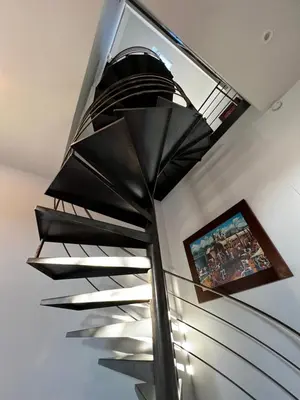 a glass staircase with a television in the ceiling at B&B Den Engel in Kortenberg