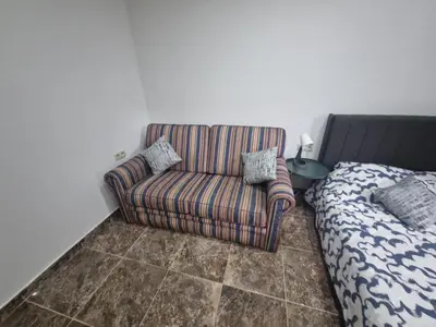 a living room with a couch next to a bed at Luxe Bruxelles in Brussels