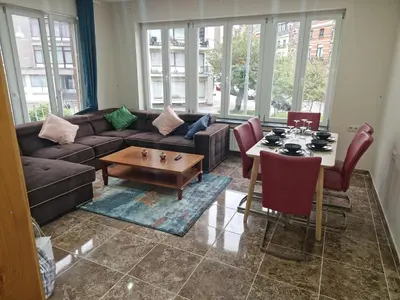 a living room with a couch and a table at Luxe Bruxelles in Brussels