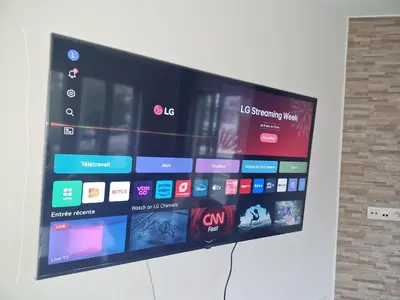 a large flat screen tv hanging on a wall at Luxe Bruxelles in Brussels