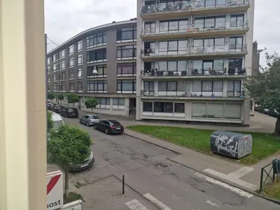 an apartment building with cars parked in front of it at Luxe Bruxelles in Brussels