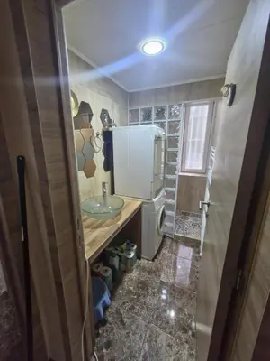 a small kitchen with a sink and a refrigerator at Luxe Bruxelles in Brussels