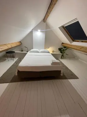 a bedroom with a large bed in a attic at Attic European Quarter in Brussels