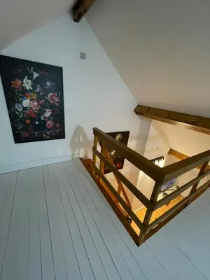 an attic room with a painting on the wall at Attic European Quarter in Brussels
