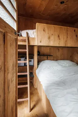 a bunk bed and a ladder in a wooden room at Bosuil in Retie