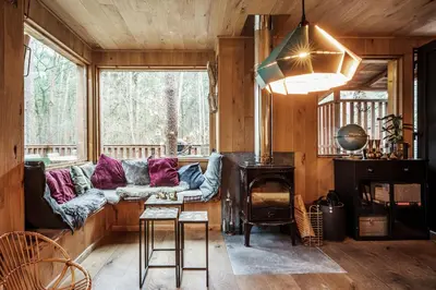 a living room with a couch and a fireplace at Bosuil in Retie