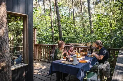 a group of people sitting at a table on a deck at Bosuil in Retie