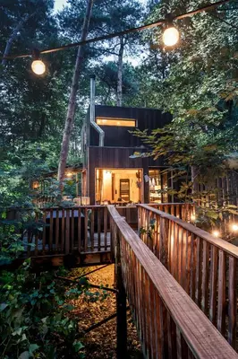 a cabin in the woods with a wooden fence at Bosuil in Retie