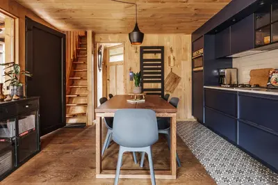a small kitchen with a wooden table and chairs at Bosuil in Retie