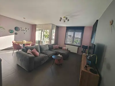 a living room with a couch and a table at Casa Rosa Leuven in Herent