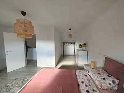 a living room with a couch and a hallway at Casa Rosa Leuven in Herent