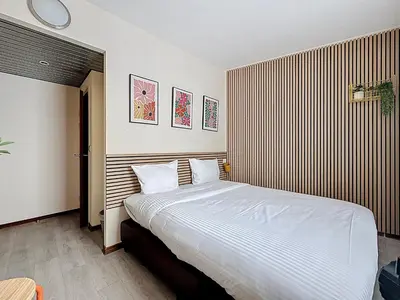 a bedroom with a large bed with white sheets at Slina Hotel Brussels in Brussels