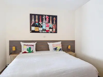 a bedroom with a white bed with bottles on the wall at Slina Hotel Brussels in Brussels
