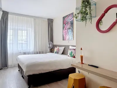 a bedroom with a large bed and a window at Slina Hotel Brussels in Brussels