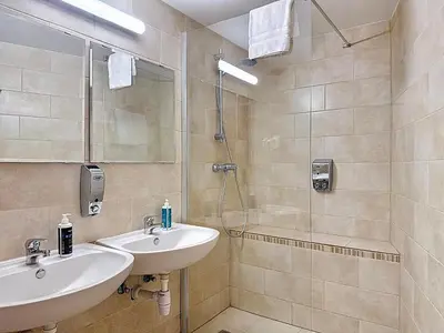 a bathroom with a sink and a shower at Slina Hotel Brussels in Brussels