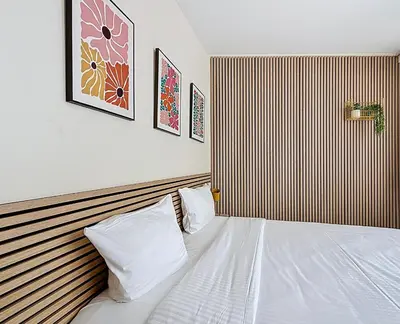 a bedroom with a white bed and a striped wall at Slina Hotel Brussels in Brussels