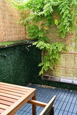 a wooden bench sitting next to a brick wall at Brussels Midi Apartment in Brussels