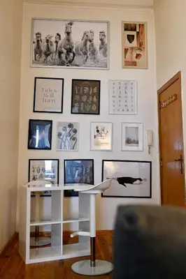 a room with a white desk and pictures on the wall at Brussels Midi Apartment in Brussels
