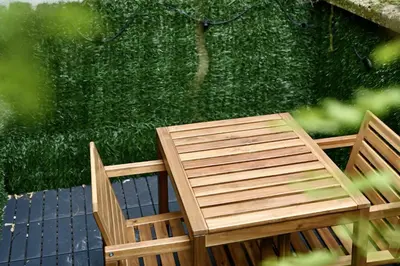 a wooden table and chairs sitting on a patio at Brussels Midi Apartment in Brussels