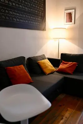 a black couch with colorful pillows on it at Brussels Midi Apartment in Brussels