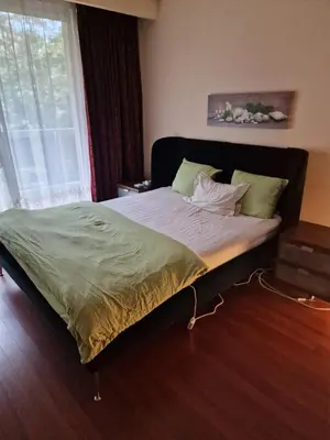 a large bed in a bedroom with a window at La ferme rose in Brussels