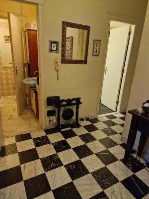 a bathroom with a checkered floor and a mirror at La ferme rose in Brussels