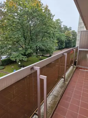 a balcony with a view of a park at La ferme rose in Brussels