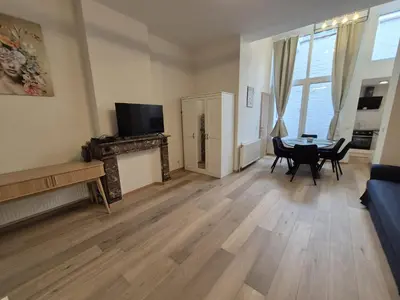 a living room with a couch and a table at Tasson Snel apartment center of Brussels in Brussels