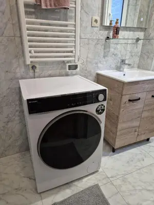 a microwave in a bathroom with a sink at Tasson Snel apartment center of Brussels in Brussels