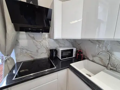 a kitchen with a sink and a microwave at Elegant apartment in center of Brussels in Brussels