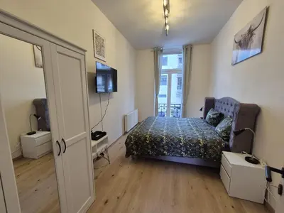 a bedroom with a bed and a television in it at Elegant apartment in center of Brussels in Brussels