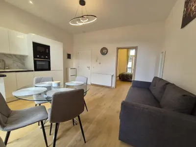 a living room with a couch and a table at Elegant apartment in center of Brussels in Brussels