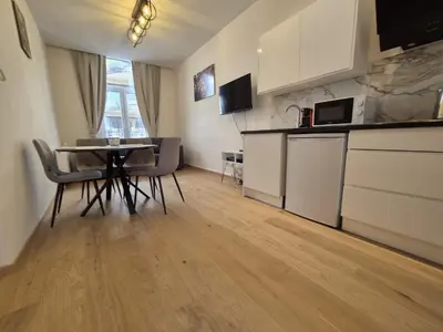 a kitchen with a table and chairs in a room at Modern apartment near Avenue Louise in Brussels