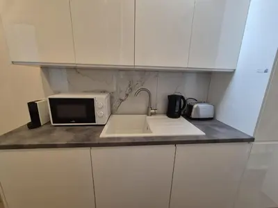 a kitchen counter with a sink and a microwave at Modern apartment near Avenue Louise in Brussels