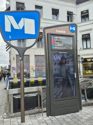 a phone booth and a sign on a street at Modern apartment near Avenue Louise in Brussels