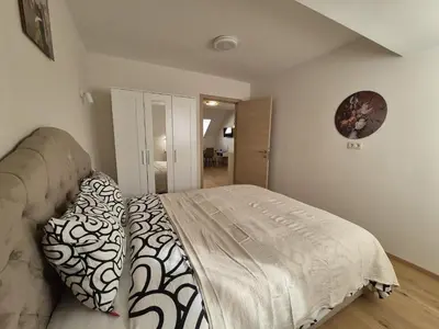 a bedroom with a bed and a couch in it at Cosy duplex in center of Brussels in Brussels