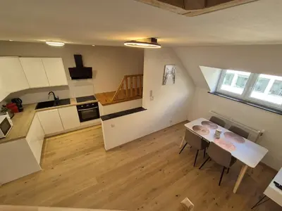 an overhead view of a kitchen and dining room with a table at Cosy duplex in center of Brussels in Brussels